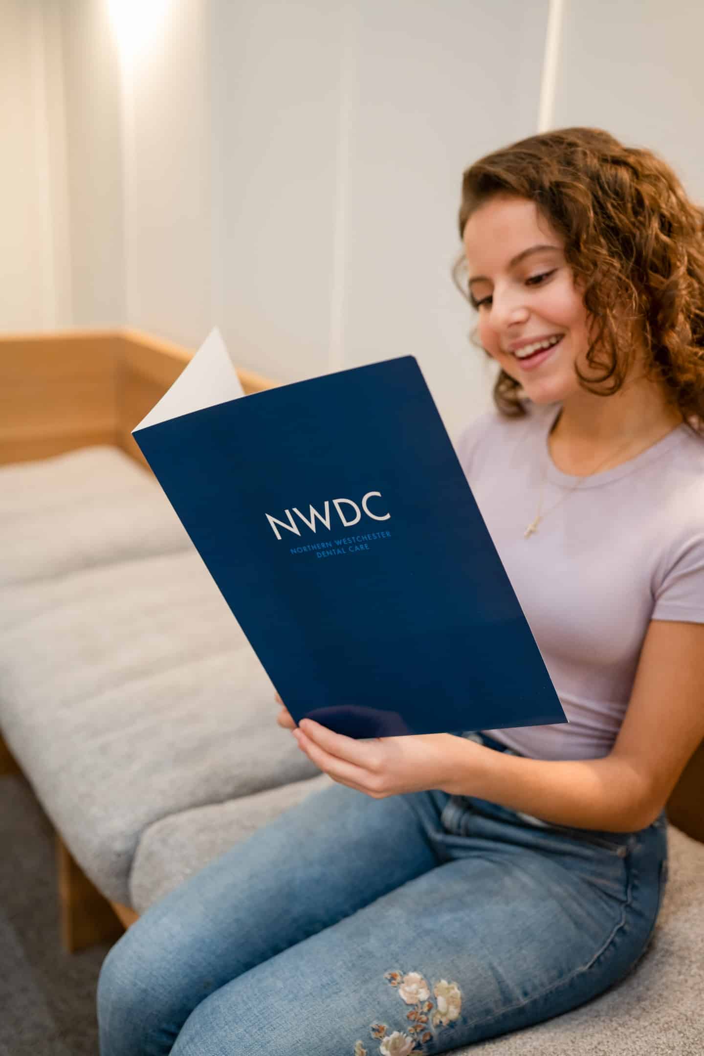 Patient reviews a folder labeled NWDC
